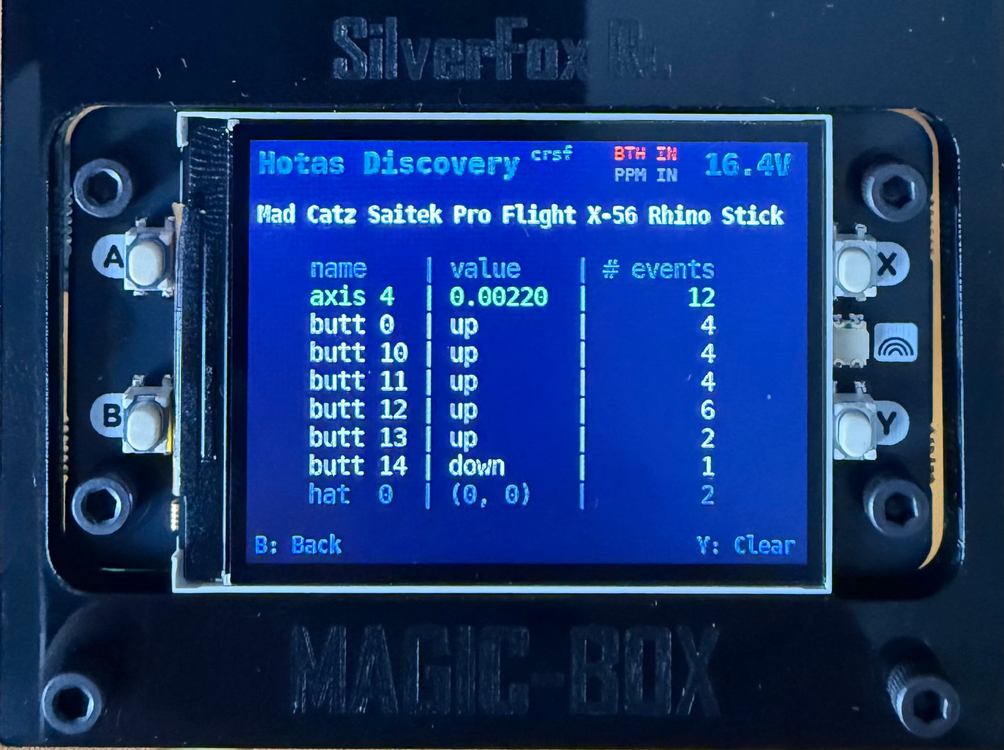 Magic Box 2" IPS screen fitted in the top plate, running the HOTAS discovery view — live axis values, button events and input voltage, with the four on-device buttons A/B/X/Y